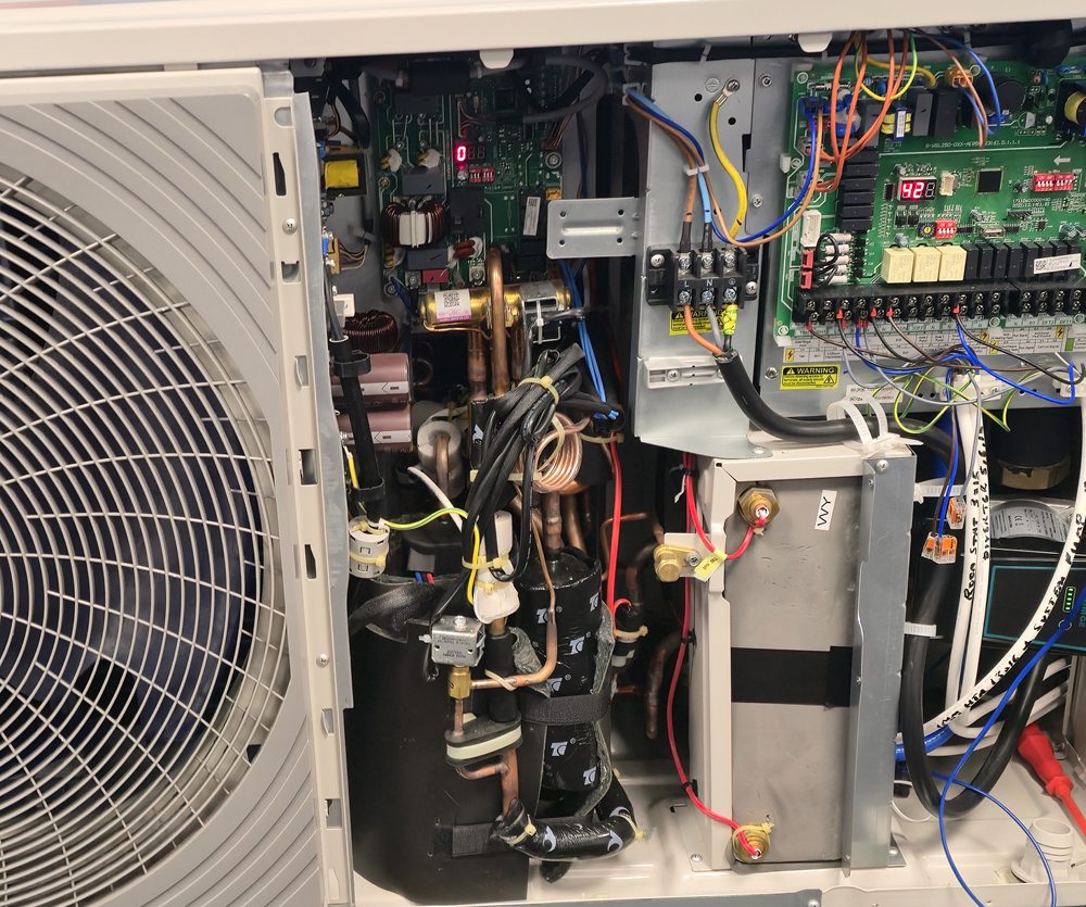 Inside an air source heat pump: compressor, controls and wiring